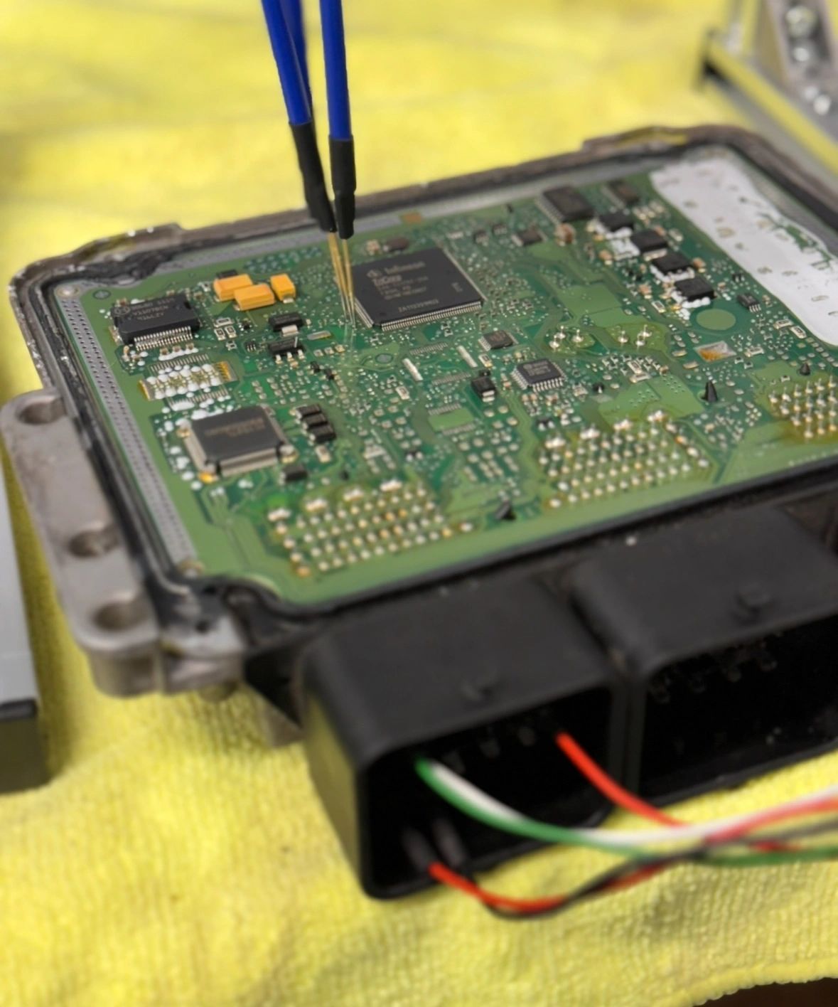 Electronic control module circuit board being inspected — ECU repair